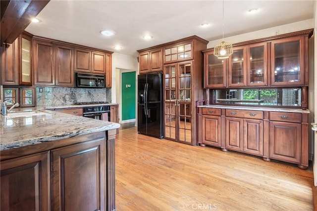 2322 W 156th St, Gardena, CA 90249 - kitchen featuring black appliances, light wood finished floors, decorative light fixtures, tasteful backsplash, and light stone counters