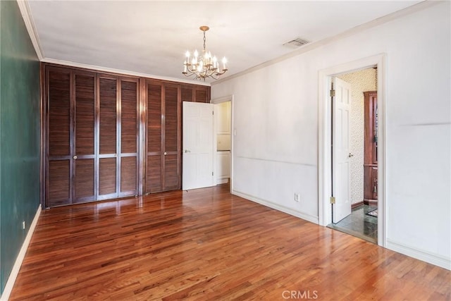 2322 W 156th St, Gardena, CA 90249 - unfurnished bedroom with wood finished floors, a chandelier, and crown molding