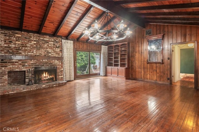 2322 W 156th St, Gardena, CA 90249 - unfurnished living room featuring wooden walls, hardwood / wood-style floors, wood ceiling, a fireplace, and a chandelier