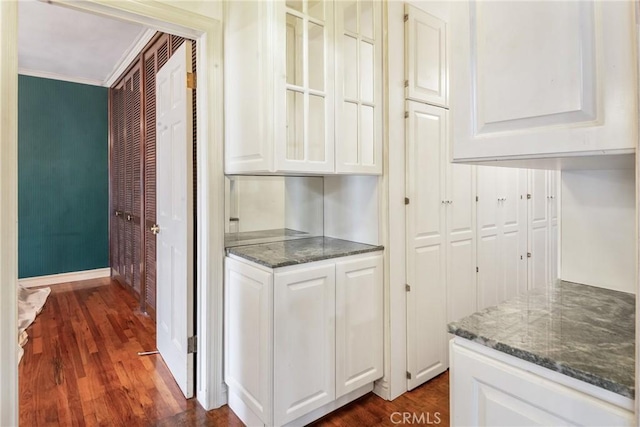 2322 W 156th St, Gardena, CA 90249 - kitchen with ornamental molding, dark wood finished floors, white cabinetry, dark stone countertops, and glass insert cabinets