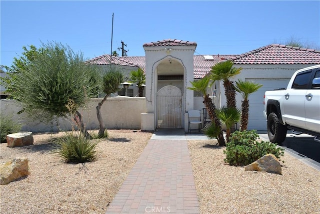 31811 Whispering Palms Trl, Cathedral City, CA 92234 - mediterranean / spanish home with a garage, stucco siding, and a tiled roof