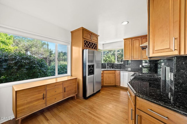 1620 Knollwood Dr, Pasadena, CA 91103 - kitchen featuring stainless steel appliances, dark stone countertops, decorative backsplash, light wood-style floors, and brown cabinetry