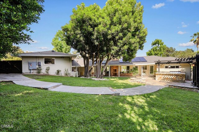 1620 Knollwood Dr, Pasadena, CA 91103 - back of property with roof mounted solar panels, stucco siding, and a patio area