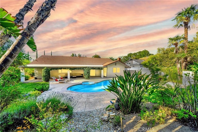 3811 Algonaut Dr, Calabasas, CA 91302 - pool at dusk with a patio area, an outdoor pool, and outdoor lounge area
