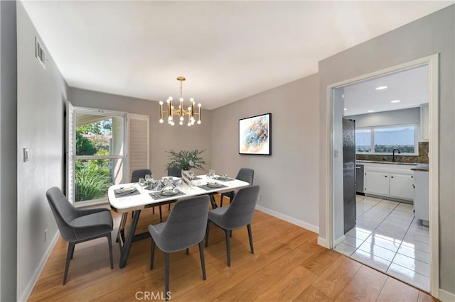 3811 Algonaut Dr, Calabasas, CA 91302 - dining space with a chandelier, plenty of natural light, and light wood-style floors