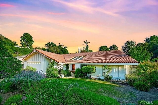 3811 Algonaut Dr, Calabasas, CA 91302 - single story home with a tile roof, an attached garage, board and batten siding, and a front yard