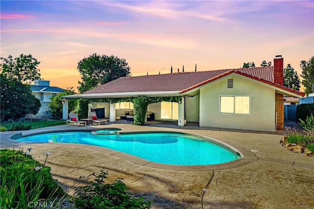 3811 Algonaut Dr, Calabasas, CA 91302 - pool at dusk featuring a patio and a pool with connected hot tub