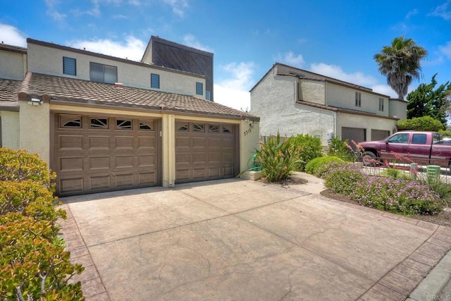 2315 Nicklaus Dr, Oceanside, CA 92056 - view of home's exterior featuring concrete driveway, stucco siding, and an attached garage