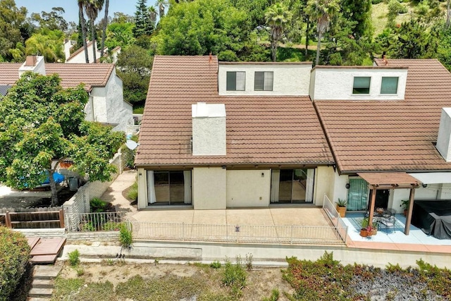 2315 Nicklaus Dr, Oceanside, CA 92056 - back of property featuring a tiled roof, a patio area, and stucco siding
