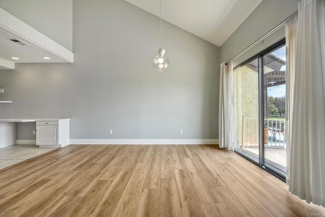 2315 Nicklaus Dr, Oceanside, CA 92056 - unfurnished dining area with light wood-style floors and high vaulted ceiling