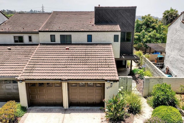 2315 Nicklaus Dr, Oceanside, CA 92056 - view of front of property with a tiled roof, stucco siding, a garage, and driveway
