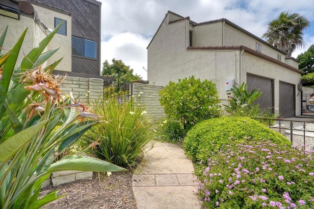 2315 Nicklaus Dr, Oceanside, CA 92056 - view of side of home featuring stucco siding and an attached garage