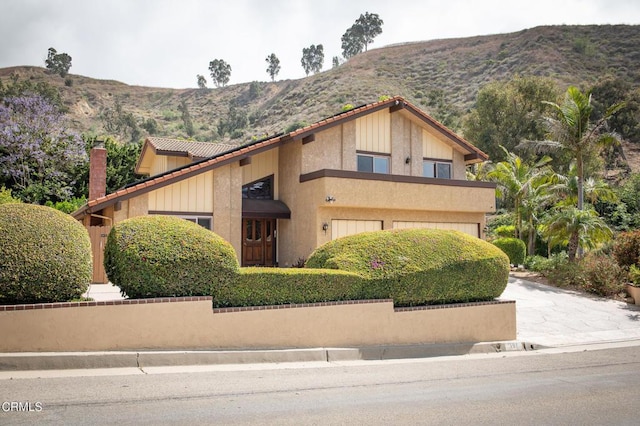 191 Haborview Ct, Ventura, CA 93003 - view of front of property featuring a tiled roof, a mountain view, a chimney, and an attached garage