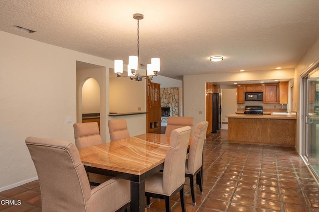 191 Haborview Ct, Ventura, CA 93003 - dining space featuring a chandelier, a textured ceiling, and tile patterned flooring