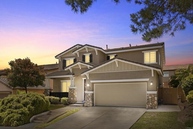 1222 N Creekside Dr, Chula Vista, CA 91915 - view of front of home with stone siding, driveway, stucco siding, a garage, and a tiled roof