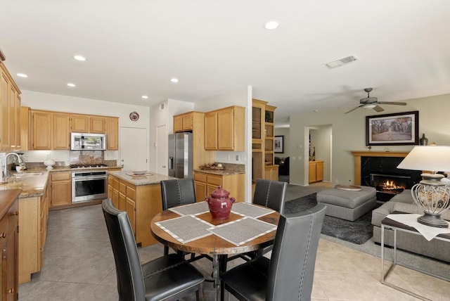 1222 N Creekside Dr, Chula Vista, CA 91915 - dining space with light tile patterned floors, a premium fireplace, a ceiling fan, and recessed lighting