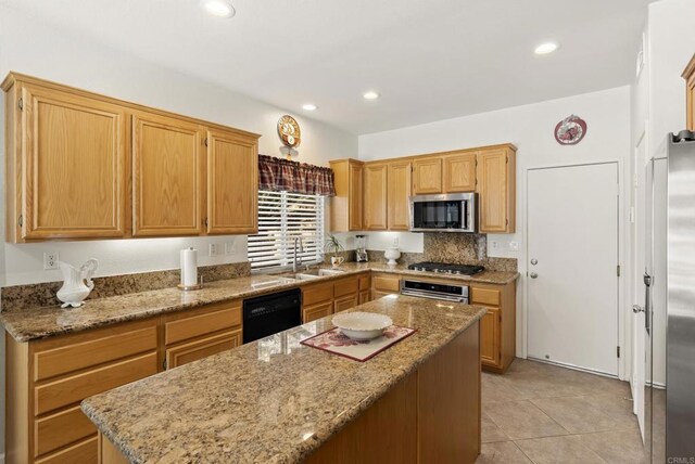 1222 N Creekside Dr, Chula Vista, CA 91915 - kitchen with appliances with stainless steel finishes, a center island, light stone countertops, light tile patterned floors, and recessed lighting