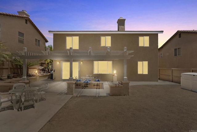 1222 N Creekside Dr, Chula Vista, CA 91915 - back of property at dusk featuring a pergola, a patio area, stucco siding, and a chimney