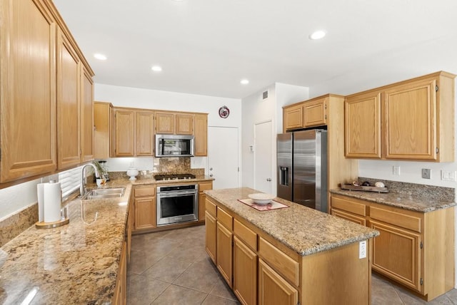 1222 N Creekside Dr, Chula Vista, CA 91915 - kitchen featuring appliances with stainless steel finishes, a kitchen island, light stone countertops, tile patterned flooring, and recessed lighting