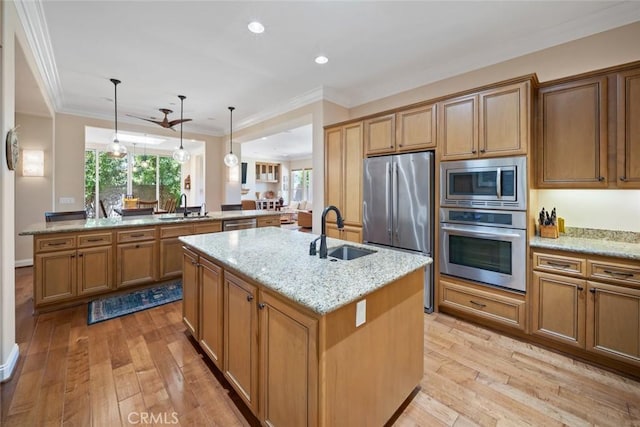 1432 Vicki Ln, Nipomo, CA 93444 - kitchen featuring stainless steel appliances, a center island with sink, light wood-style flooring, light stone counters, and crown molding