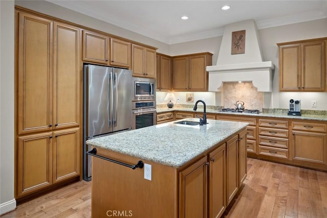 1432 Vicki Ln, Nipomo, CA 93444 - kitchen featuring appliances with stainless steel finishes, light wood-style floors, light stone countertops, premium range hood, and crown molding