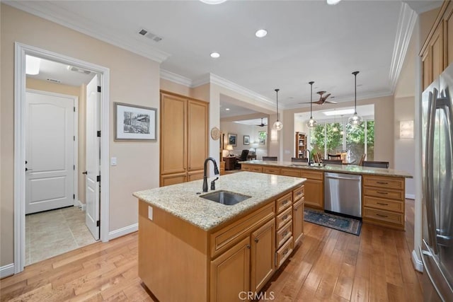 1432 Vicki Ln, Nipomo, CA 93444 - kitchen featuring appliances with stainless steel finishes, a center island with sink, light wood finished floors, ceiling fan, and light stone counters