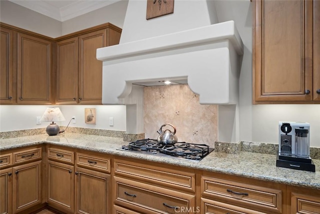 1432 Vicki Ln, Nipomo, CA 93444 - kitchen featuring stainless steel gas stovetop, ventilation hood, brown cabinets, light stone counters, and decorative backsplash