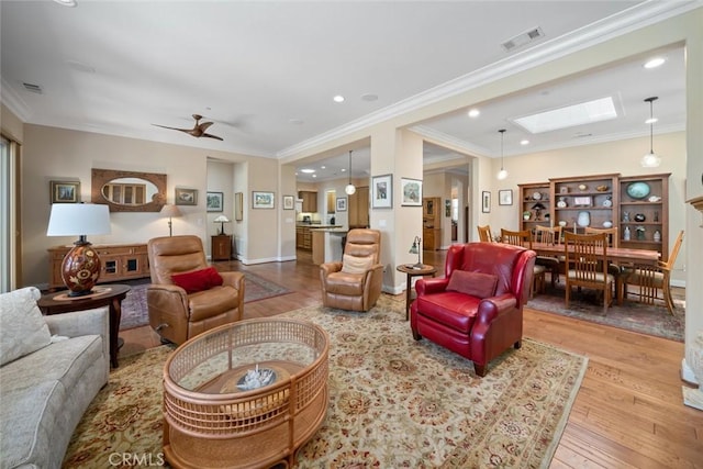 1432 Vicki Ln, Nipomo, CA 93444 - living room with wood-type flooring, a skylight, recessed lighting, ornamental molding, and ceiling fan