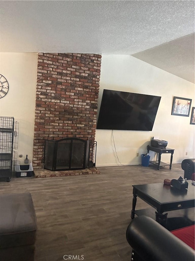 245 Broadway St, Lake Elsinore, CA 92530 - living room with a brick fireplace, a textured ceiling, wood finished floors, and lofted ceiling