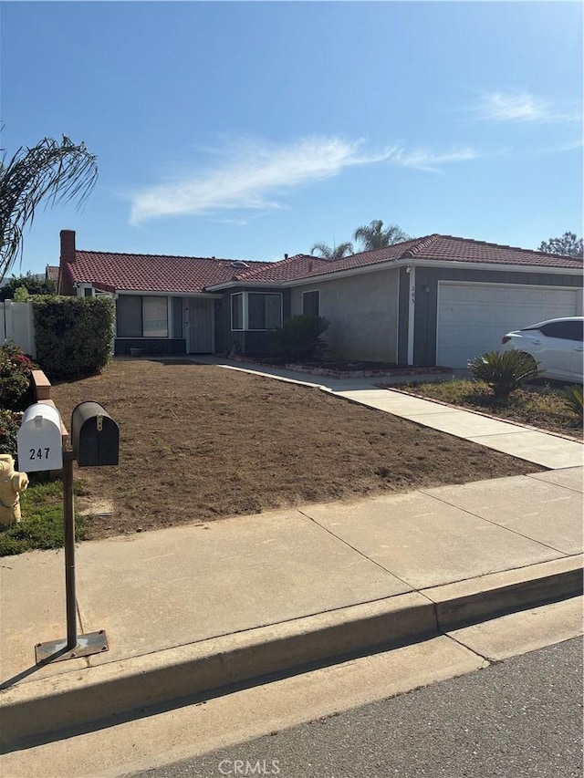 245 Broadway St, Lake Elsinore, CA 92530 - ranch-style home featuring an attached garage, a tile roof, concrete driveway, and stucco siding