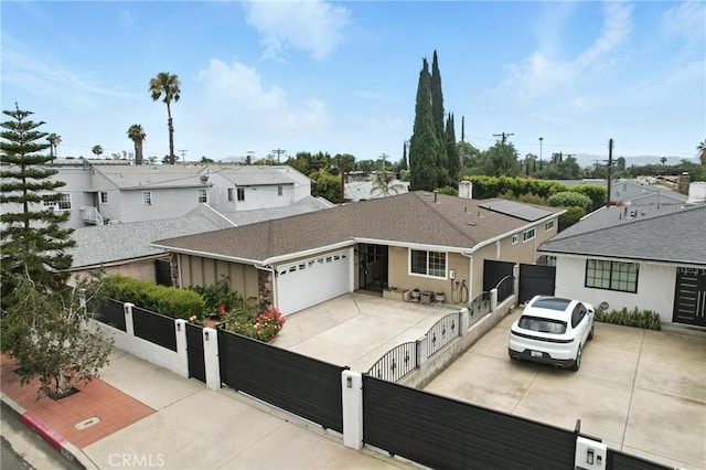 12516 Archwood St, North Hollywood, CA 91606 - view of front facade featuring a fenced front yard, a gate, a garage, driveway, and stucco siding