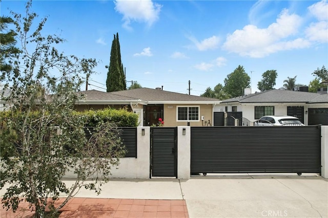 12516 Archwood St, North Hollywood, CA 91606 - view of front of house with a fenced front yard, stucco siding, driveway, and a gate