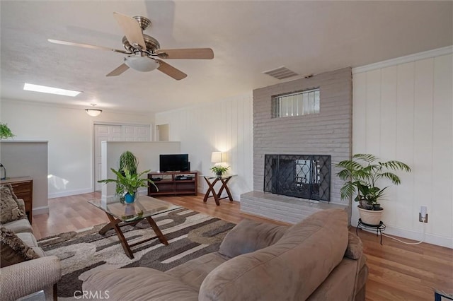 6354 Berkshire Ave, Paradise, CA 95969 - living room with a brick fireplace, a ceiling fan, and wood finished floors