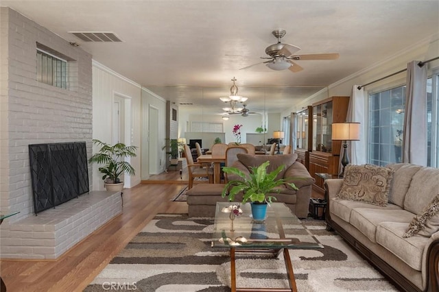 6354 Berkshire Ave, Paradise, CA 95969 - living room with wood finished floors, crown molding, ceiling fan, plenty of natural light, and a fireplace