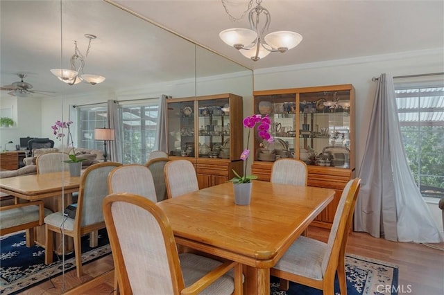6354 Berkshire Ave, Paradise, CA 95969 - dining area with a chandelier, ceiling fan, wood finished floors, and ornamental molding