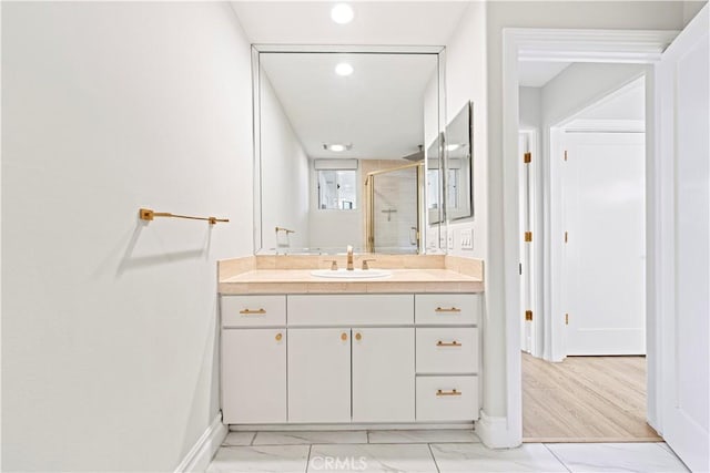 390 S Sepulveda Blvd Unit 105, Los Angeles, CA 90049 - bathroom with a shower stall, vanity, recessed lighting, and marble look tiles