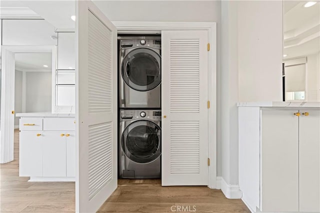 390 S Sepulveda Blvd Unit 105, Los Angeles, CA 90049 - laundry area with stacked washer and clothes dryer, light wood-style floors, and recessed lighting