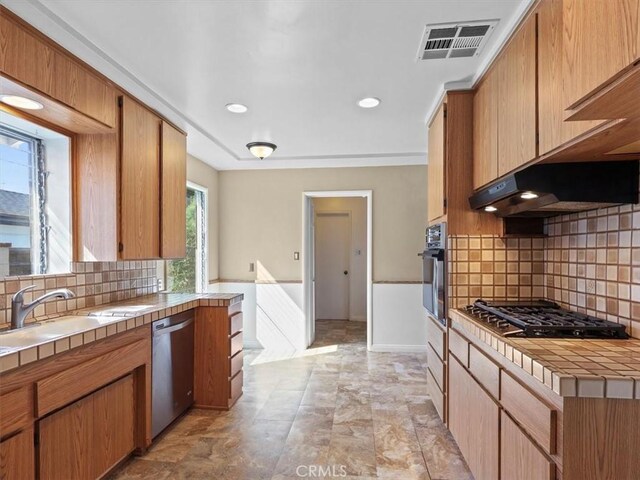 13510 Valleyheart Dr N, Sherman Oaks, CA 91423 - kitchen featuring tile countertops, dishwasher, gas stovetop, black oven, and under cabinet range hood