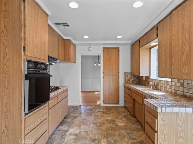 13510 Valleyheart Dr N, Sherman Oaks, CA 91423 - kitchen with black oven, tile countertops, decorative backsplash, recessed lighting, and range hood