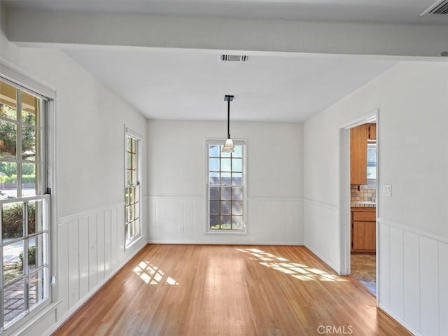 13510 Valleyheart Dr N, Sherman Oaks, CA 91423 - unfurnished dining area featuring a wainscoted wall, light wood finished floors, and beam ceiling