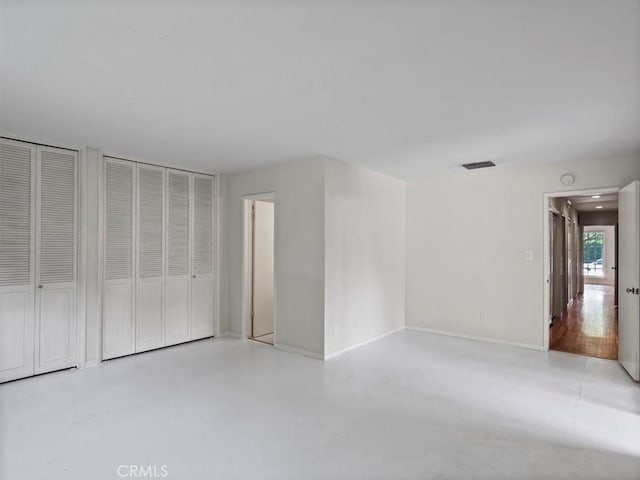 13510 Valleyheart Dr N, Sherman Oaks, CA 91423 - unfurnished bedroom with finished concrete flooring and multiple closets