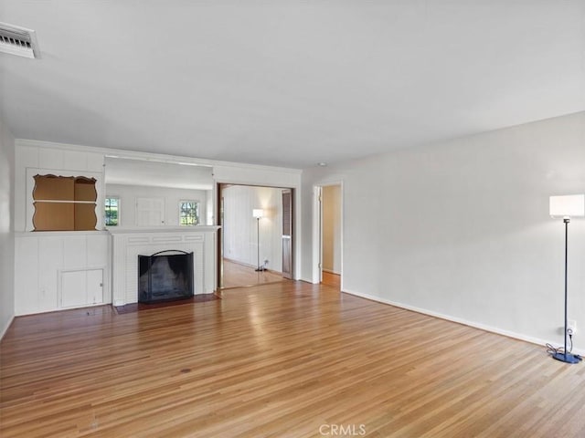 13510 Valleyheart Dr N, Sherman Oaks, CA 91423 - unfurnished living room featuring light wood finished floors and a fireplace
