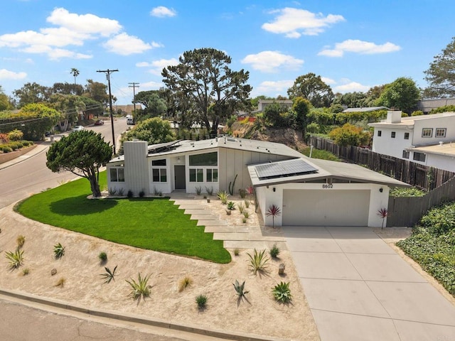 8602 Kilbourn Dr, La Jolla, CA 92037 - mid-century home with roof mounted solar panels, driveway, and a garage