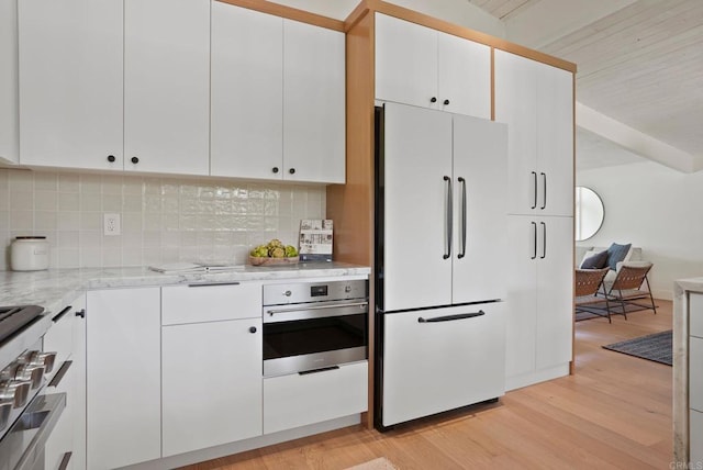 8602 Kilbourn Dr, La Jolla, CA 92037 - kitchen featuring appliances with stainless steel finishes, light wood-style flooring, tasteful backsplash, and beamed ceiling