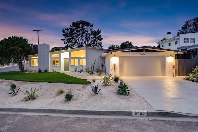 8602 Kilbourn Dr, La Jolla, CA 92037 - mid-century inspired home with a garage, concrete driveway, and stucco siding