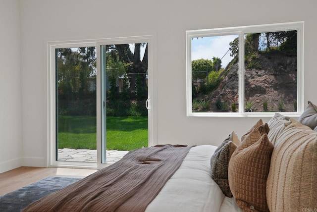 8602 Kilbourn Dr, La Jolla, CA 92037 - bedroom featuring multiple windows, access to outside, and wood finished floors