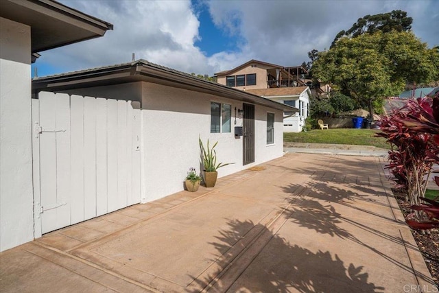 260406 Juan St, San Diego, CA 92110 - view of home's exterior featuring a patio and stucco siding
