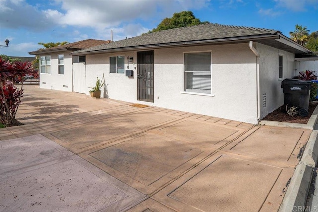 260406 Juan St, San Diego, CA 92110 - rear view of property with stucco siding, a patio area, and a shingled roof