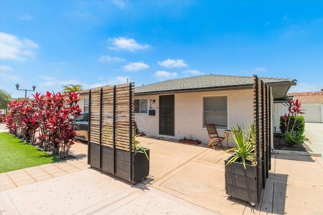260406 Juan St, San Diego, CA 92110 - rear view of house with stucco siding and a patio area