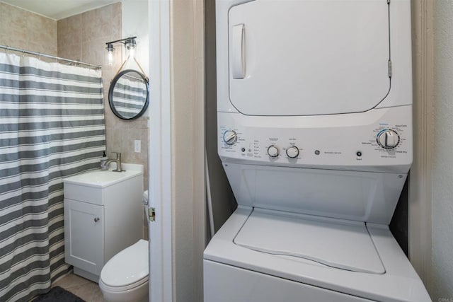 260406 Juan St, San Diego, CA 92110 - full bathroom with stacked washer and clothes dryer, vanity, curtained shower, and tile patterned flooring
